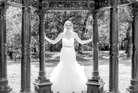 Beautiful bride holding pillars of gazebo